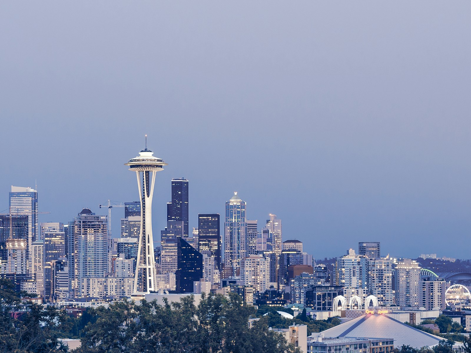 Seattle Space Needle illuminated at night above the downtown skyline